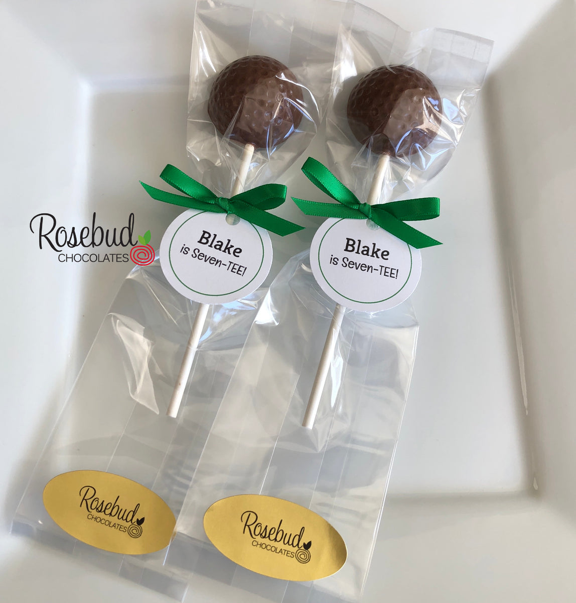 http://www.rosebudchocolates.com/cdn/shop/products/GOLFBallChocolateLollipopBlakeisSeven-teeTagPartyfavors2_1200x1200.jpg?v=1655699556